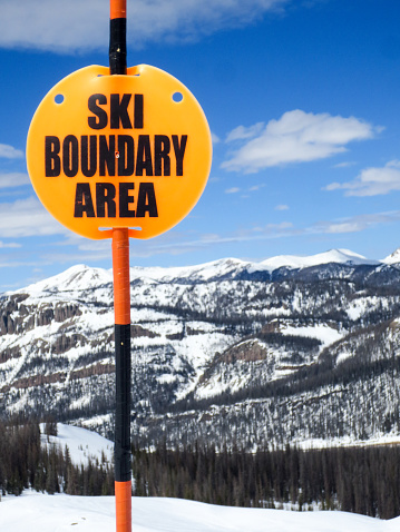 Ski resort signage warning of the ski area boundary.  These markers keep skiers and snowboarders from accidentally leaving the ski resort.