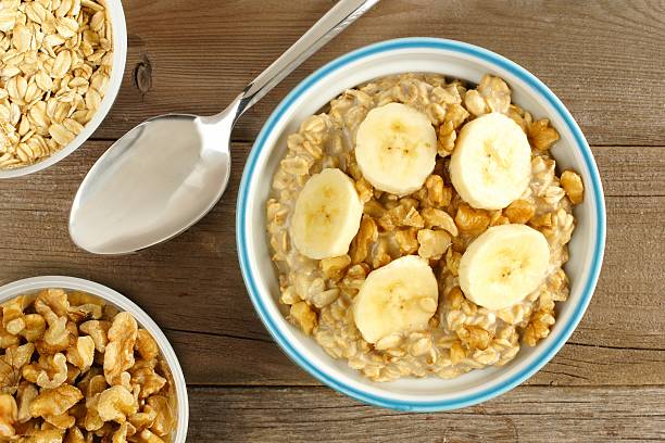 istock Banana walnut oatmeal above view on wood 468211984