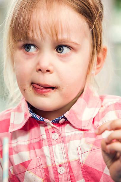 istock Little Girl Eating Chocolate Chip Cookie 468212696