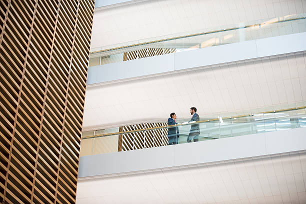 istock Low angle view of businessmen discussing on walkway 468213284