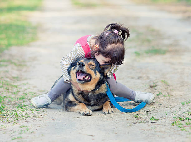 istock Happy little girl playing with dog 468213887