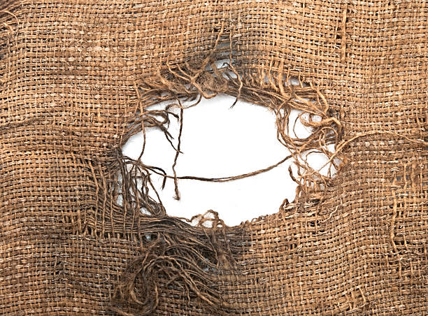 Torn burlap decayed. Ragged linen fabric. Torn burlap decayed. Ragged linen fabric. torn fabric stock pictures, royalty-free photos & images