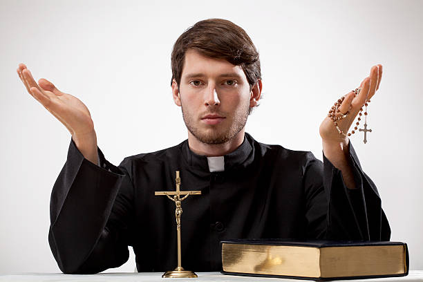 istock Young reverend with rosary and the Bible 468215933