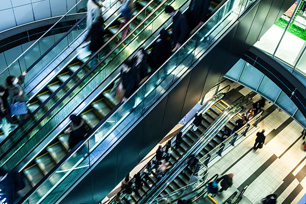 istock People at the escalator. Motion blur. 468216440