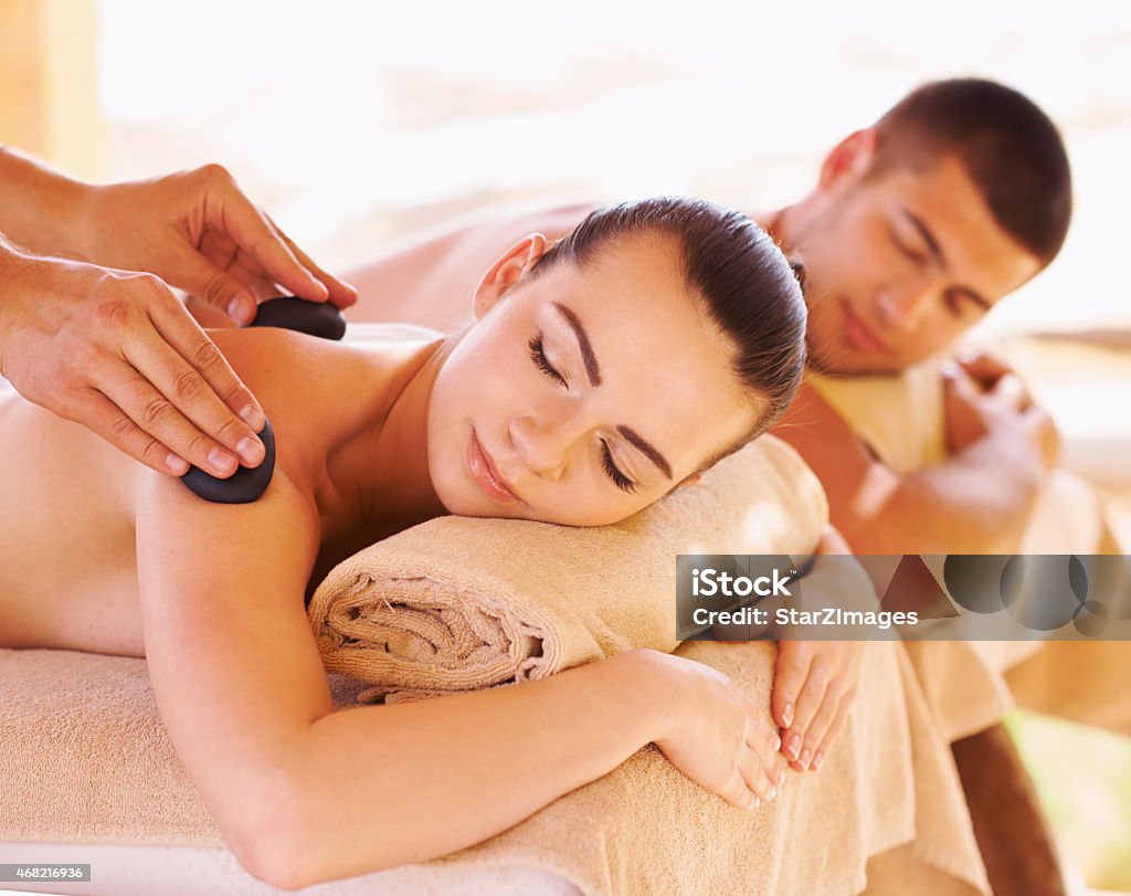 Hot stone therapy for muscle relaxation Young couple enjoying a massage seaside 20-24 Years Stock Photo