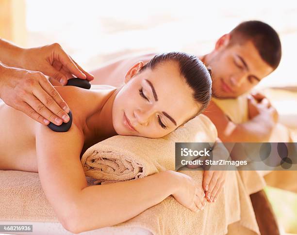 Hot Stone Therapy For Muscle Relaxation Stock Photo - Download Image Now - 20-24 Years, 2015, Adult