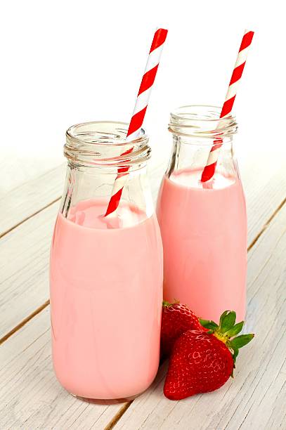 istock Two strawberry milks with red and white striped straws 468217114