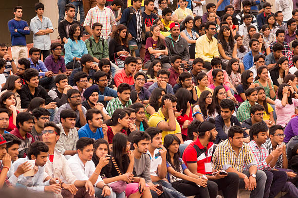 Crowd of young students watching Delhi, India; 14th Mar 2015 - Crowd of young students, men and women watching a show in Delhi india crowd stock pictures, royalty-free photos & images