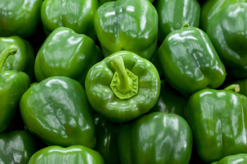 Fresh green bell peppers background