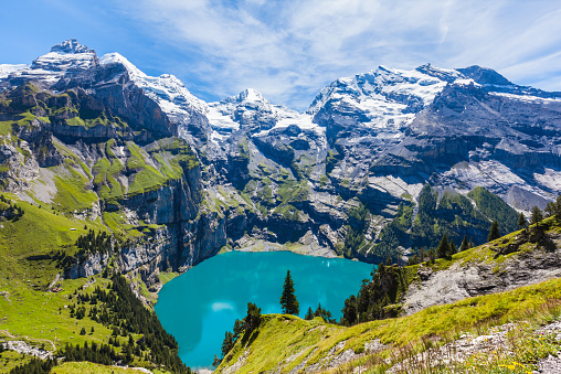 Swiss Alps Matterhorn Mountain Peak in Summer reflecting in Riffelsee Lake under blue sunny summer Skyscape. 16:9 Panorama Shot. Matterhorn, Zermatt, Switzerland, Europe.