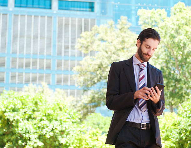 istock Young businessman reading text message on mobile phone 468228174