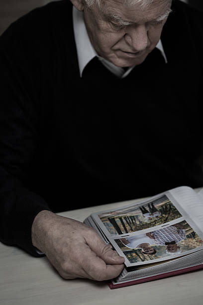 istock Widower in mourn watching photos 468235366