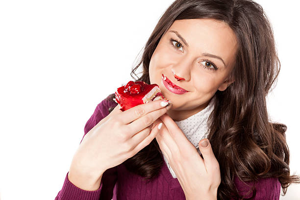 stained girl eating cake Happy stained girl eating cake tasting cherry eating human face stock pictures, royalty-free photos & images