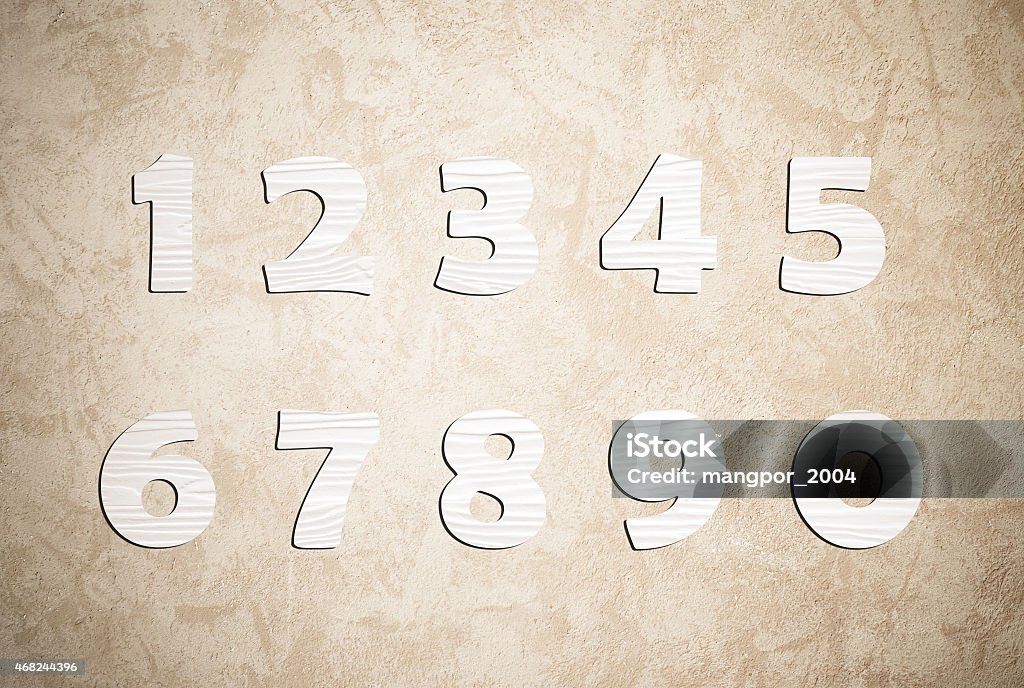 White wooden numbers on cement wall background White wooden numbers on cement wall background, zero to nine 2015 Stock Photo