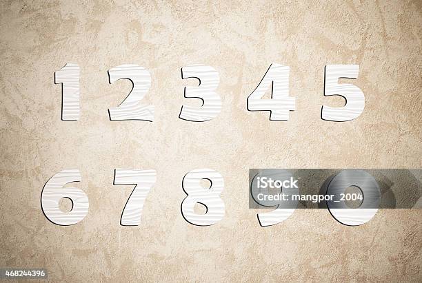 White Wooden Numbers On Cement Wall Background Stock Photo - Download Image Now - 2015, Alphabet, Carpentry