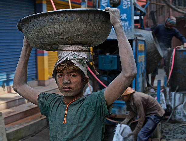 Stolen Childhood Kathmandu, Nepal - January 17th, 2015: Homeless boys are working in construction for a food and shelter in the capital city of Nepal. child labor stock pictures, royalty-free photos & images