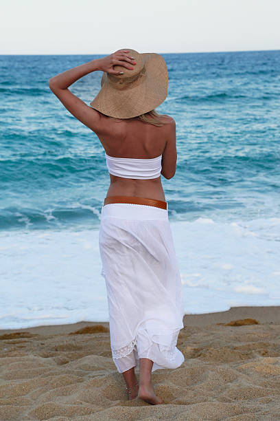 istock Girl in hat on the beach 468253886