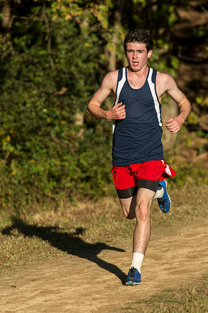 Caucasian male athlete running on a trail