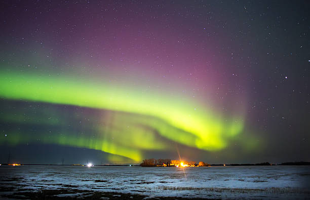 istock Curving aurora borealis over winter landscape 468257788