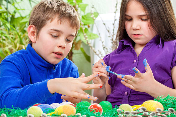 istock Mother and her children paint easter eggs 468264070