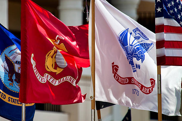 Military Standards Standards of three of the US Military services on parade and waving in the Central Florida afternoon. navy photos stock pictures, royalty-free photos & images