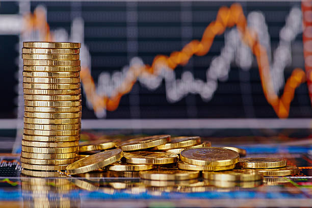 istock Golden coins and financial chart as background 468265653