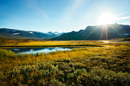 Scenic view of grassland and lake in front of a remote mountain range at sunset. Jotunheimen national park, Norway. Nobody. Nature. XXXL (Sony Alpha 7R)