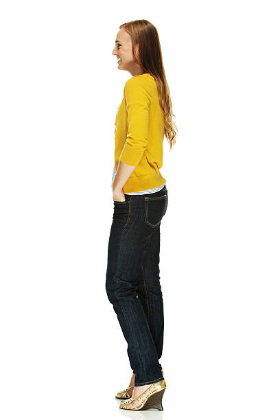 istock Cheerful woman standing with hands in pockets 468289345