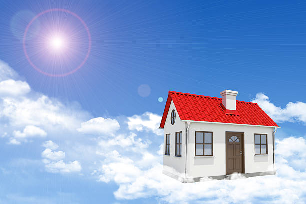 istock White house with red gable roof and chimney in clouds 468299630
