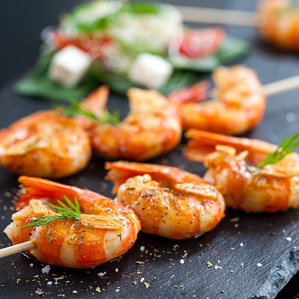 istock Shrimp tails grilled on wood skewer. 468306510