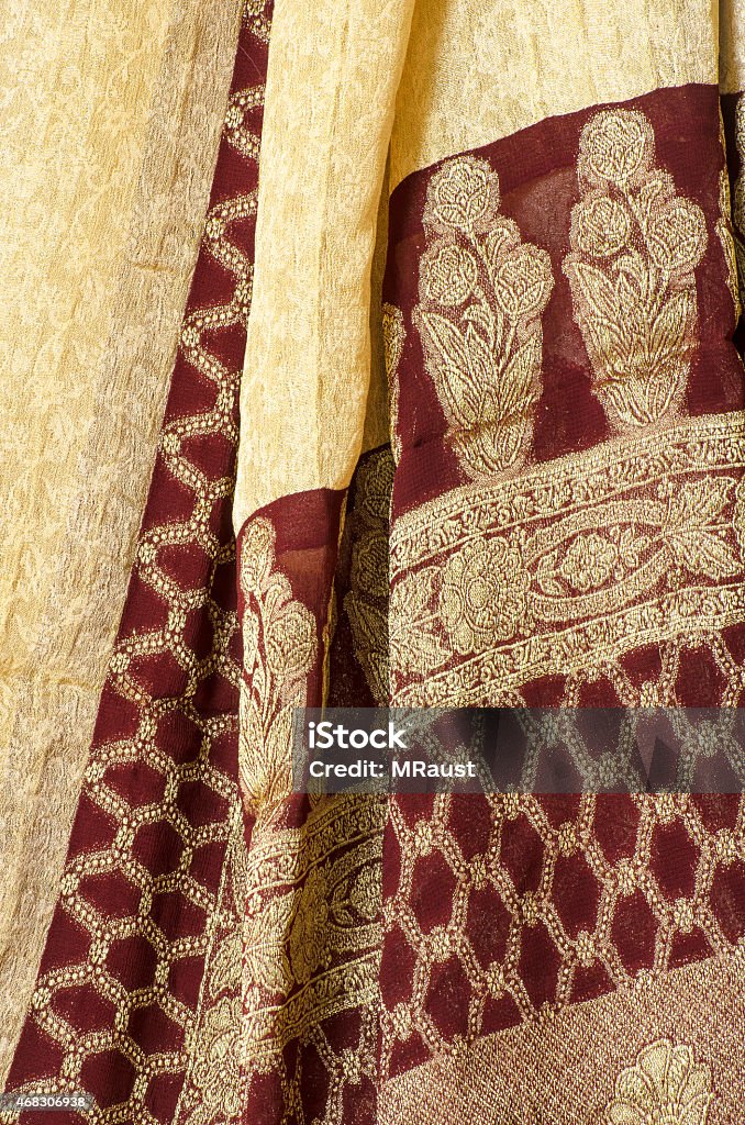 Red and Gold Sari fabric Elegant red and gold Sari fabric hanging in a market. Full Frame Stock Photo