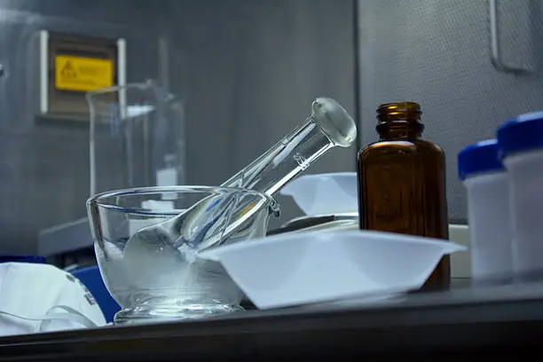 Pharmaceutical compounding equipment, including a glass pestle and mortar ready for use. 