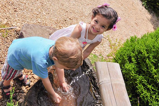 children in the garden washing hands