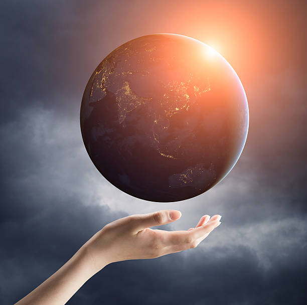 istock hand holding earth planet on a palm 468318174