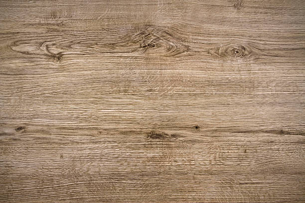 Rough light natural wooden board. Scratches, cracks and knots are strongly expressed. A wood grain pattern running horizontally across the image.