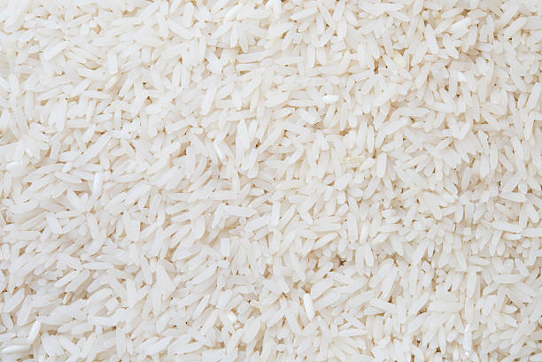istock White long rice background, uncooked raw cereals, macro closeup 468318376