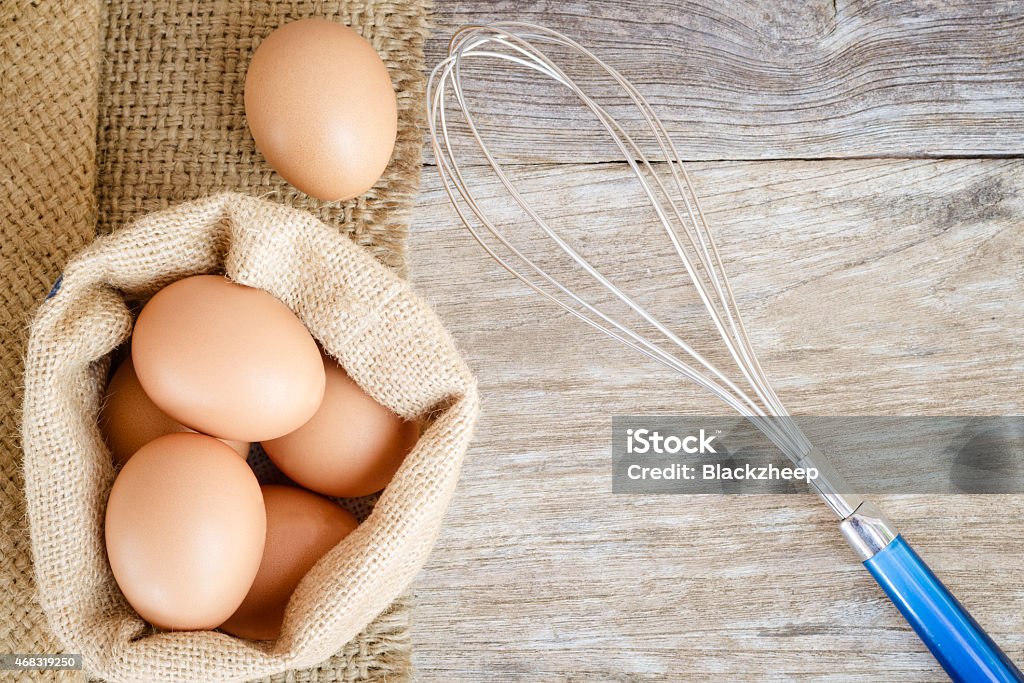chicken egg raw food on grain wood background 2015 Stock Photo