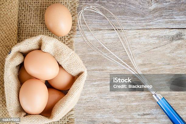 Chicken Egg Raw Food On Grain Wood Background Stock Photo - Download Image Now - 2015, Agriculture, Backgrounds