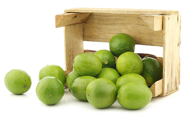 istock lime fruits in a wooden crate 468319634