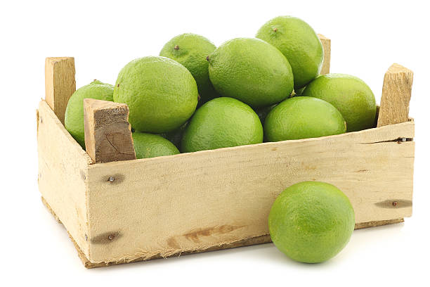 istock lime fruits in a wooden crate 468322358