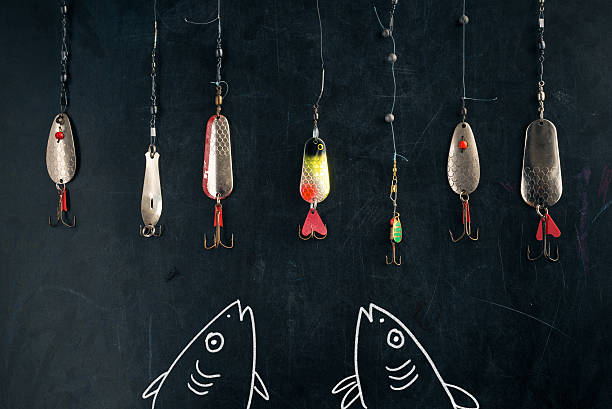 two drawn fishes snapping at the lure at chalk board