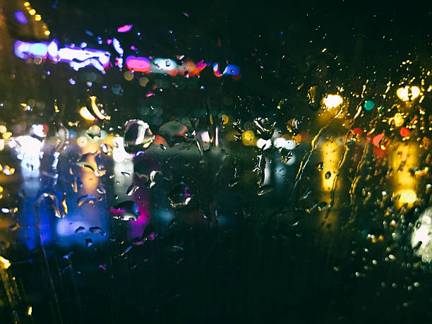 istock View of a building at night through a rain spattered window 468326652