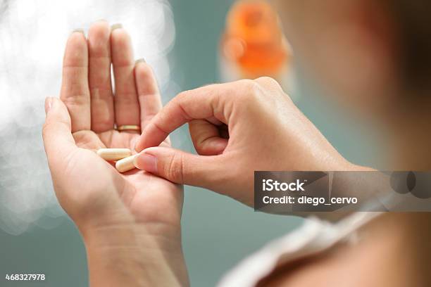 Young Woman Taking Vitamins Ginseng Pill Stock Photo - Download Image Now - Capsule - Medicine, Pill, Nutritional Supplement