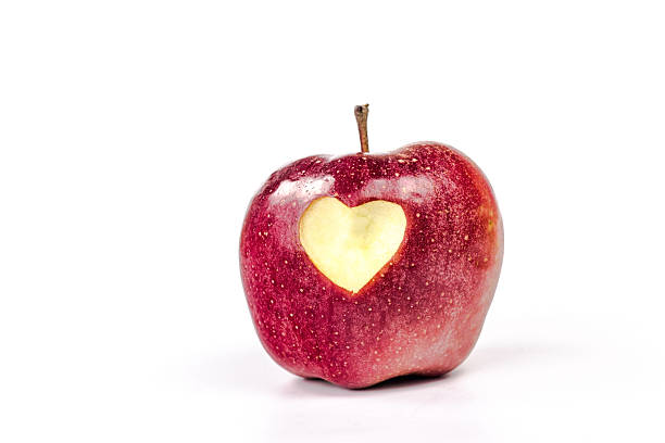 istock red apple with carved heart isolated 468329404