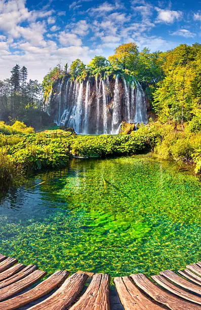 Landscape of a beautiful rock with a waterfall under the blue sky. Plitvice Lakes National Park is the oldest national park in Southeast Europe and the largest national park in Croatia.