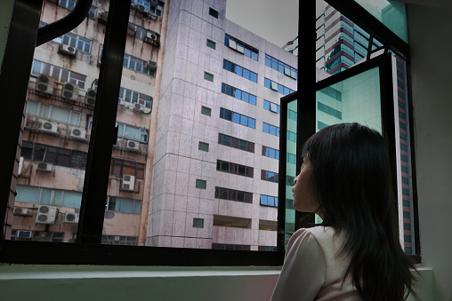 girl looking at polluted building surface