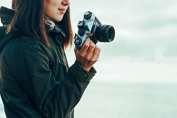 istock Smiling girl with old photo camera 468331280