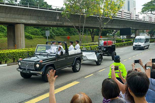 Singapore, Singapore - March 29, 2015: The people line up along the Commonwealth Avenue to bid their final farewell to the founding prime minister Mr Lee Kuan Yew, the Funeral Cortege headed to Mandai Crematorium for private funeral service after State Funeral Service.