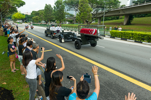 Singapore, Singapore - March 29, 2015: The people line up along the Commonwealth Avenue to bid their final farewell to the founding prime minister Mr Lee Kuan Yew, the Funeral Cortege headed to Mandai Crematorium for private funeral service after State Funeral Service.