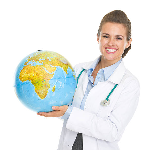 istock smiling doctor woman holding earth globe 468334287